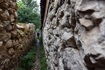 Narrow village alley with stone walls