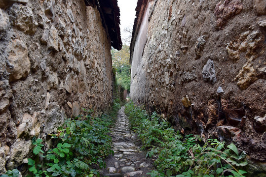 Narrow village alley with stone walls