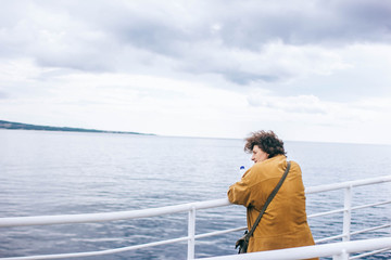 Fototapeta premium woman on a ferry looking into the sea distance