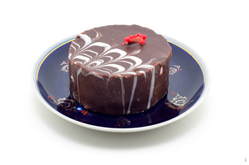 Chocolate cake on a plate isolated on white background.