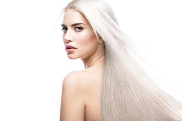 Beautiful blond girl in move with a perfectly smooth hair, and classic make-up. Beauty face....