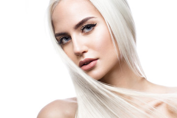 Beautiful blond girl in move with a perfectly smooth hair, and classic make-up. Beauty face. Picture taken in the studio. - obrazy, fototapety, plakaty