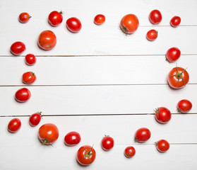 Naklejka na ściany i meble Tomatoes on white wooden table.