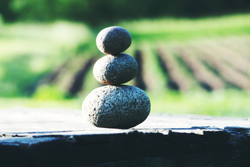 Three stones on a wooden table