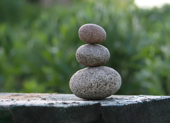 Fototapeta na wymiar Three stones on a wooden table