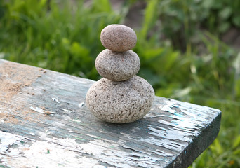 Three stones on a wooden table
