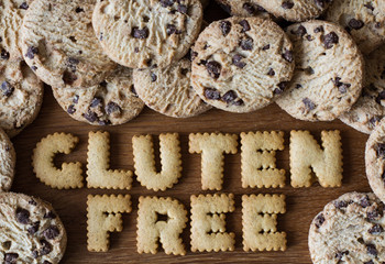 The phrase Gluten Free spelled out with alphabet shaped cookies and surrounded by biscuits.
