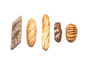 Different kinds of bread on white top view