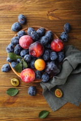 Sweet and ripe plums on wood