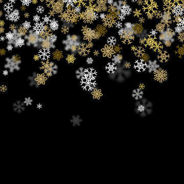 Snowfall background with golden snowflakes blurred in the dark