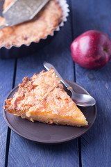 Slice of homemade apple pie on a wooden background. Autumn fruit pie