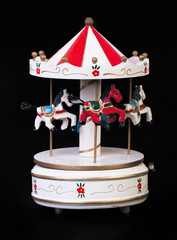 Obraz premium Old Toy wooden carousel on a black background