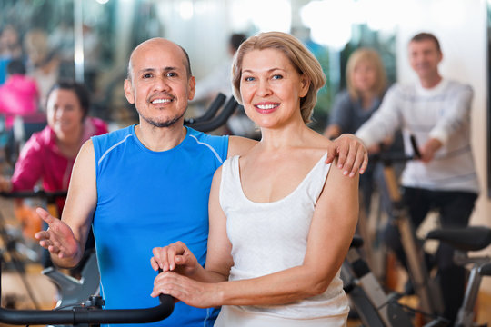 Sportive couple in a fitness club with friends
