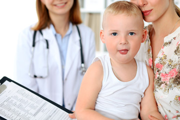 Little boy child  with his mother  after health exam at doctor's office