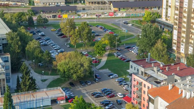 Cars moving on parking lot timelapse with green trees. CROATIA, ZAGREB