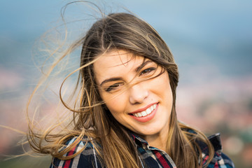 Portrait of beautiful young blonde woman on windy day