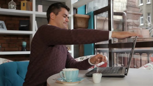 Man finishes to work on laptop