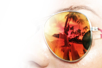 Palm trees reflect in sunglasses