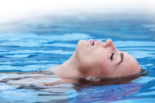 Woman floating in pool