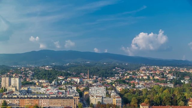 Panorama of the city center timelapse of Zagreb, Croatia, with modern and historic buildings, mountains on background.