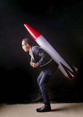 asian business man and strategy rocket on back ,business competi