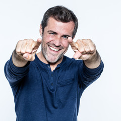 happy handsome young man smiling pointing his fingers forwards