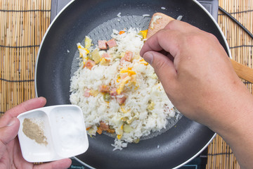 Chef putting salt and pepper for cooking fried rice