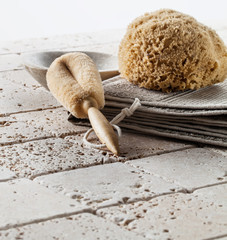 loofah brush, sponge and cup for purity over limestone background
