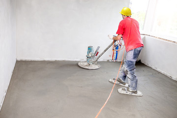 Employee performs sand and cement screed floor. Sand and cement floor screed