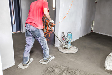 Employee performs sand and cement screed floor. Sand and cement floor screed