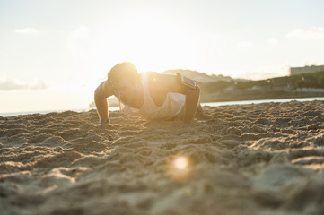 Spain, Mallorca, Jogger at the beach at sunrise, pushups