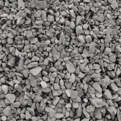Abstract grey and beige gravel stone background, crushed gray stones and granite pieces texture, large detailed horizontal textured rough construction rock material mix pattern
