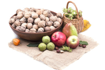 delicious ripe apples with pears near Walnut and hazelnuts on sa