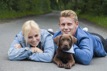 young couple with a labrador puppy