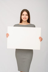 happy woman holding white blank paper