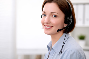  Young beautiful business woman in headset. Call center.