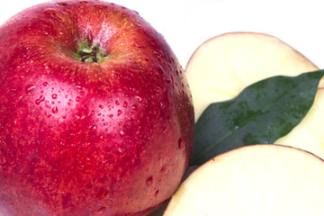 one big red apple close with two threaded pieces