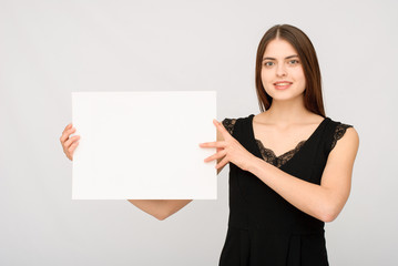 Obraz na płótnie Canvas Smiling woman with empty board