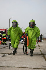 Naklejka premium firemen in action, Firefighters exercises train accident, chemical contamination 