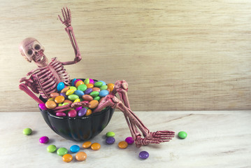 skeleton in black bucket and candy
