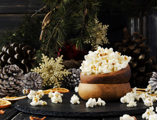 popcorn in a wooden plate on the background of Christmas