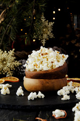 popcorn in a wooden plate on the background of Christmas