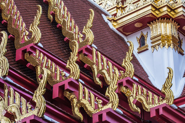 Golden gable apex on the roof of  Thai temple, Bangkok, Thailand.   