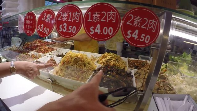 Customers Choosing Cooked Street Food on Asian Food Market