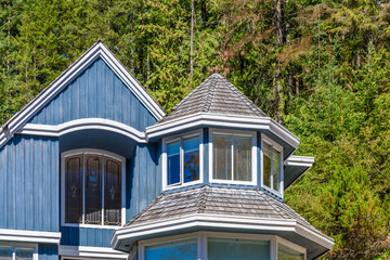The top of the house or apartment building with nice window.