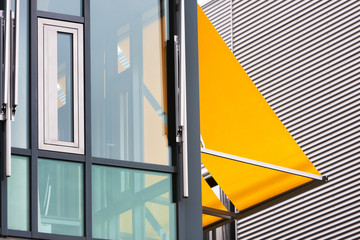 Modern office building with yellow awnings