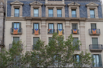 Catalan flag Estelada hanging from balconies in Barcelona, Spain.
The full name of the flag in Spanish is La Senyera Estelada, the starred flag.
