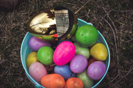 multicolored plastic easter eggs and golden money egg