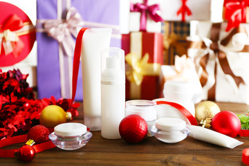 Beauty cosmetic products with Christmas decoration on blurred gifts background