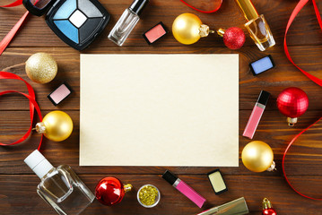 Naklejka na ściany i meble Paper with colorful makeup cosmetic and Christmas decoration on wooden background